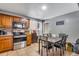 Kitchen and dining area with stainless steel appliances, wood cabinets, and dining table with chairs at 5519 Tucson St, Denver, CO 80239
