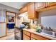 Efficient kitchen area with stainless steel sink, stove, and convenient access to adjacent living space at 5519 Tucson St, Denver, CO 80239