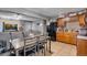 Open-concept kitchen and dining area with stainless appliances, wood cabinets, and granite counters at 5519 Tucson St, Denver, CO 80239