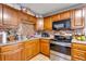 Kitchen featuring granite countertops, stainless steel appliances, and a mosaic tile backsplash at 5519 Tucson St, Denver, CO 80239
