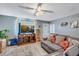 Cozy living room with a comfortable sofa, entertainment center, and lots of natural light at 5519 Tucson St, Denver, CO 80239