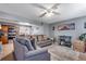 Comfortable living room with gray sectional sofa, view into the kitchen, and plenty of natural light at 5519 Tucson St, Denver, CO 80239