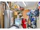 Utility room with water heater, laundry equipment, and shelving for organized storage solutions at 5519 Tucson St, Denver, CO 80239