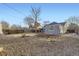 Spacious backyard with mature trees, patio area, and detached garage at 2555 Hudson St, Denver, CO 80207