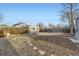 The large, private backyard features a patio area and a detached garage at 2555 Hudson St, Denver, CO 80207