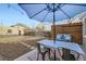 Backyard patio with an umbrella, outdoor seating and a privacy fence for relaxing at 2555 Hudson St, Denver, CO 80207