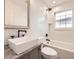 Bathroom featuring white subway tile, stylish fixtures, and a large vanity mirror at 2555 Hudson St, Denver, CO 80207