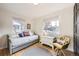 Cozy bedroom with natural light from two windows features a comfortable daybed and stylish decor at 2555 Hudson St, Denver, CO 80207