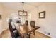 Elegant dining room with a wooden table, modern light fixture, and view of the kitchen at 2555 Hudson St, Denver, CO 80207