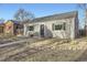 Charming home with gray brick, black shutters, metal railings, and a walkway leading to the front door at 2555 Hudson St, Denver, CO 80207