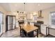 Kitchen featuring butcher block island, stainless appliances, and white cabinets open to dining area at 2555 Hudson St, Denver, CO 80207