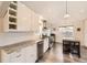 Bright kitchen features stainless appliances, ample storage, grey countertops, and sleek, modern finishes at 2555 Hudson St, Denver, CO 80207