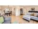 Open-concept living room with hardwood floors seamlessly connecting to the dining area and kitchen at 2555 Hudson St, Denver, CO 80207