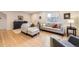 Bright living room with hardwood floors, neutral furniture, and a large window for natural light at 2555 Hudson St, Denver, CO 80207