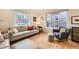 Comfortable living room featuring hardwood floors, a cozy armchair, and a large window at 2555 Hudson St, Denver, CO 80207
