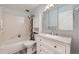 Clean bathroom featuring a vanity with drawers, tub with shower, and tile floors at 3022 S Wheeling S Way # 410, Aurora, CO 80014
