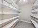 Walk-in closet with ample shelving and tiled floors ready for organization at 3022 S Wheeling S Way # 410, Aurora, CO 80014
