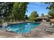 Relaxing outdoor pool area surrounded by trees and lounge chairs for sunny leisure at 3022 S Wheeling S Way # 410, Aurora, CO 80014