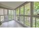 Bright sunroom with tile floors and large windows showcasing leafy trees and ample natural light at 3022 S Wheeling S Way # 410, Aurora, CO 80014