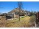 Expansive backyard with grass, trees, and a covered patio, offering a serene outdoor space at 34 Sommerset Cir, Englewood, CO 80111