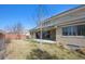 Lush backyard featuring a covered patio, mature trees, and well-maintained grass, perfect for outdoor enjoyment at 34 Sommerset Cir, Englewood, CO 80111