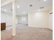 Bright basement featuring neutral carpeting, recessed lighting, and access to an additional room or storage area at 34 Sommerset Cir, Englewood, CO 80111