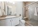 Bathroom featuring granite counters, white cabinetry, and glass enclosed shower at 34 Sommerset Cir, Englewood, CO 80111