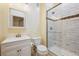 Updated bathroom featuring a modern vanity, toilet, and tiled shower with a glass enclosure at 34 Sommerset Cir, Englewood, CO 80111
