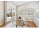 Cozy breakfast nook with large windows and sliding door leading to patio. Features a round glass table at 34 Sommerset Cir, Englewood, CO 80111