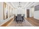 Elegant dining room with stylish chandelier, tray ceilings, and decorative wall art at 34 Sommerset Cir, Englewood, CO 80111