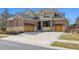 Charming two-story home features a brick exterior, tile roof, and attached two-car garage at 34 Sommerset Cir, Englewood, CO 80111
