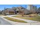 Beautiful home with a brick and stucco exterior, large driveway, and mature landscaping at 34 Sommerset Cir, Englewood, CO 80111