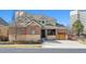 Charming two-story home featuring a brick and stucco exterior with a well-manicured lawn at 34 Sommerset Cir, Englewood, CO 80111