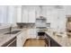 Gourmet kitchen with granite countertops, stainless steel appliances, and modern cabinetry at 34 Sommerset Cir, Englewood, CO 80111