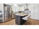 Modern kitchen with stainless steel appliances, island with granite countertops, and seating for casual dining at 34 Sommerset Cir, Englewood, CO 80111