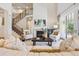 Bright living room with a fireplace, staircase, and access to the outdoors at 34 Sommerset Cir, Englewood, CO 80111