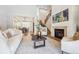 Bright living room with fireplace, staircase, and open layout to dining area at 34 Sommerset Cir, Englewood, CO 80111