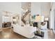 Open-concept living room showcases a fireplace, staircase, and dining area at 34 Sommerset Cir, Englewood, CO 80111