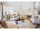 Spacious living room features fireplace, open floor plan, and connection to the kitchen at 34 Sommerset Cir, Englewood, CO 80111