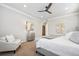 Beautiful bedroom features ceiling fan, bedside tables, and comfortable seating at 34 Sommerset Cir, Englewood, CO 80111