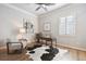 Stylish home office with hardwood floors, modern desk, and comfortable seating area at 34 Sommerset Cir, Englewood, CO 80111