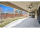 Covered patio overlooking a well-maintained backyard with a brick wall and a view of nearby buildings at 34 Sommerset Cir, Englewood, CO 80111