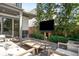 Relaxing outdoor seating area with a TV, perfect for entertaining in the backyard's tranquil and landscaped environment at 19 S Eudora St, Denver, CO 80246