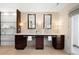 Elegant bathroom featuring dual vanities with dark wood cabinets and stone countertops at 19 S Eudora St, Denver, CO 80246