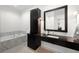 Elegant bathroom featuring a marble-encased tub, sleek vanity, and stylish fixtures at 19 S Eudora St, Denver, CO 80246