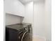 Laundry room complete with modern washer and dryer units with storage space at 19 S Eudora St, Denver, CO 80246