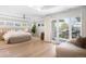 Spacious main bedroom with a sitting area, large windows, and outside access at 19 S Eudora St, Denver, CO 80246