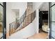 Elegant curved staircase with modern black metal railing and hardwood steps at 19 S Eudora St, Denver, CO 80246