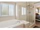 Bright bathroom features a soaking tub and a glass enclosed shower at 4713 S Ireland St, Aurora, CO 80015