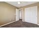 Bedroom featuring carpeted floors, ceiling fan, and closet with sliding doors at 4713 S Ireland St, Aurora, CO 80015